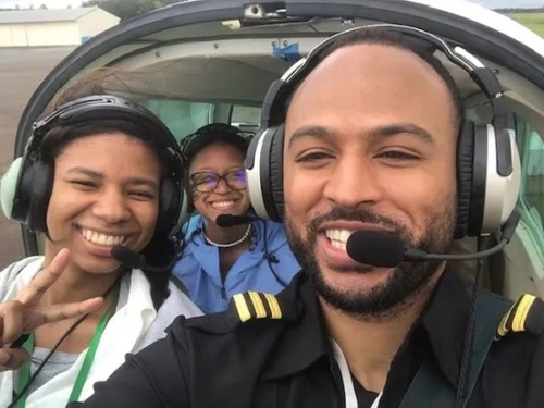 Atlanta pilot and flight instructor Omar Brock (right) is pictured in the cockpit of a plane with participants in the Brock Foundation’s annual “Gift of Flight” event in June 2022 in Anniston, Alabama. (CREDIT: Omar Brock)